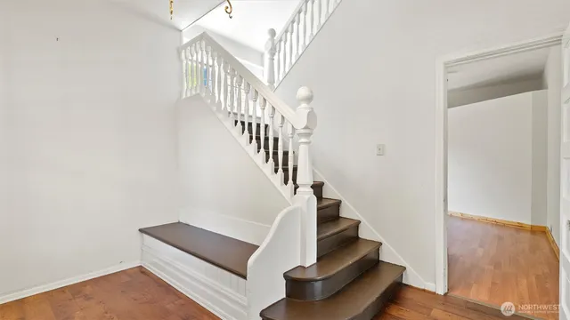 a view of entryway and hall with wooden floor