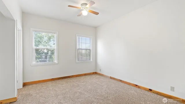 a view of a hallway with wooden shelves