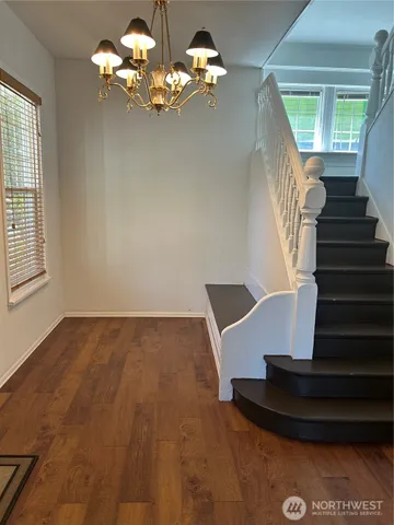 a view of entryway and hall with wooden floor