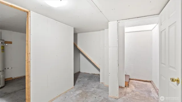 a hallway with a white door and wooden floor