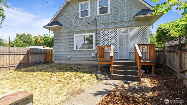 a front view of a house with a yard and trees