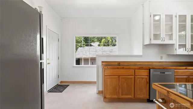 a kitchen with stainless steel appliances a sink a stove and cabinets