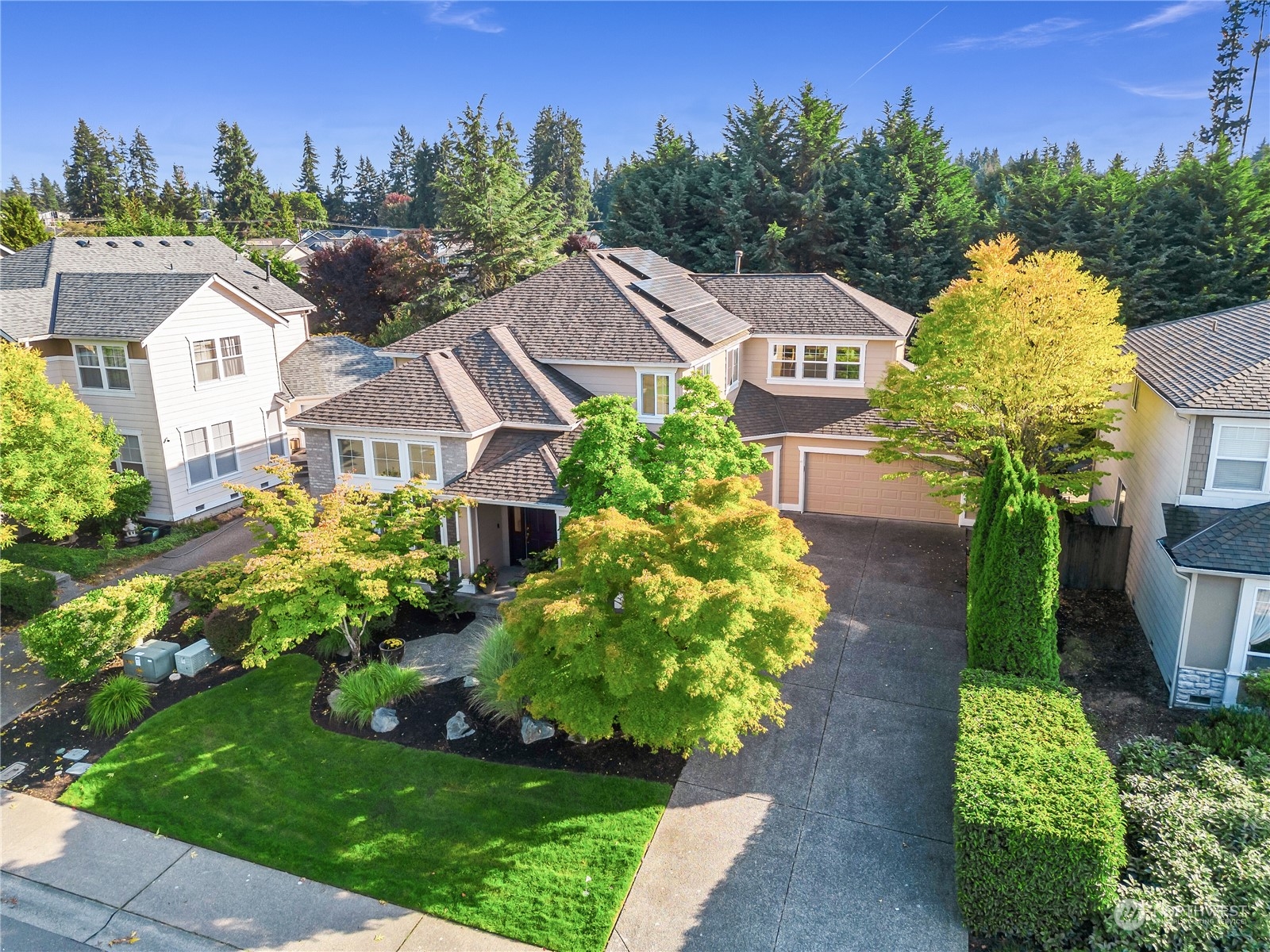 a view of a house with a garden and a yard