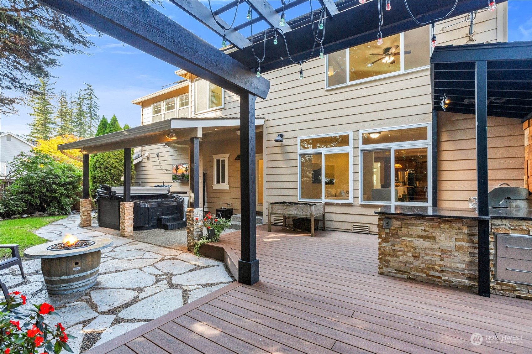 3210 187th Place Southeast Bothell, WA 98012 - Photo 37 of 39 a view of a patio with table and chairs barbeque potted plants and large tree
