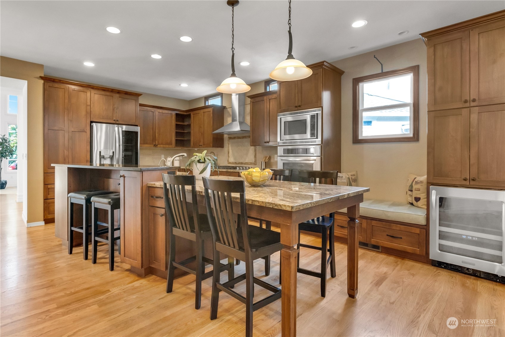 3210 187th Place Southeast Bothell, WA 98012 - Photo 8 of 39 a kitchen with stainless steel appliances kitchen island granite countertop a table chairs and a refrigerator
