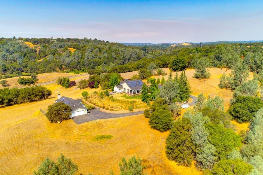 Amazing acreage featuring TWO homes, both one story with solar (solar on both transfers to Buyers)    Picture yourselves sitting on top of the world with both great privacy and views!