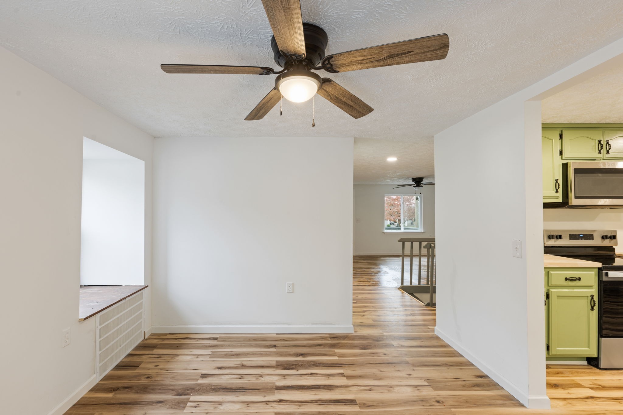 415 Durrett Street Springfield, TN 37172 - Photo 22 of 54 a view of a hallway with wooden floor and a ceiling fan