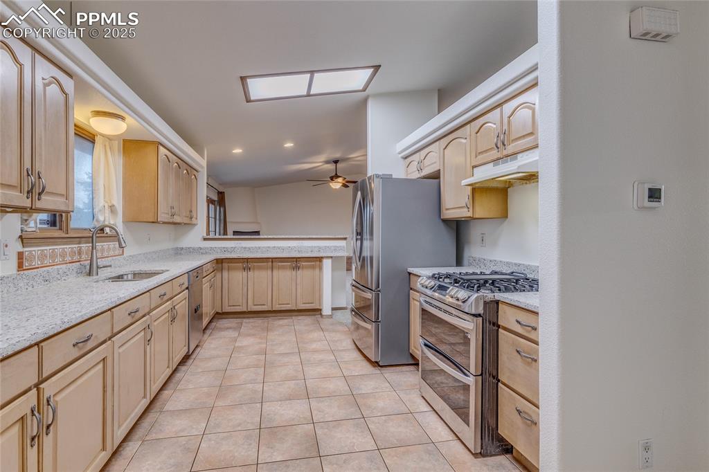 7501 Tudor Road Colorado Springs, CO 80919 - Photo 14 of 48 Kitchen from laundry room - all kitchen appliances are included.