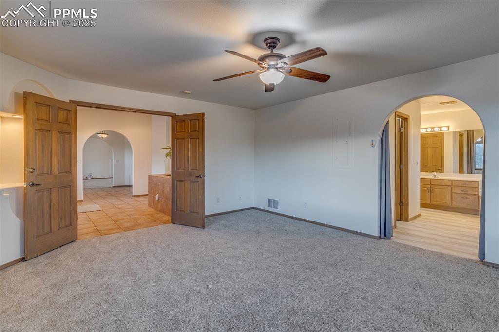 7501 Tudor Road Colorado Springs, CO 80919 - Photo 22 of 48 Primary bedroom with primary bathroom to the right.