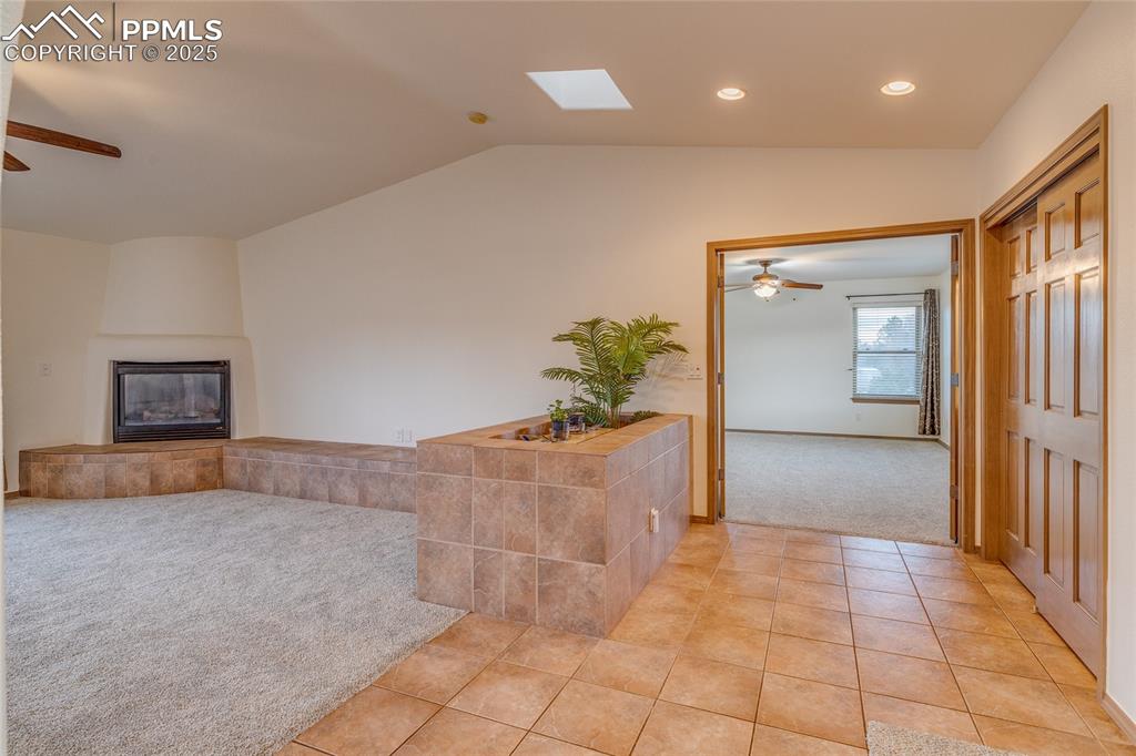 7501 Tudor Road Colorado Springs, CO 80919 - Photo 8 of 48 From dining room looking toward primary bedroom entry and family room with gas fireplace to the left