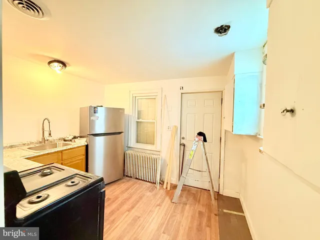 a view of a kitchen with a refrigerator and a stove