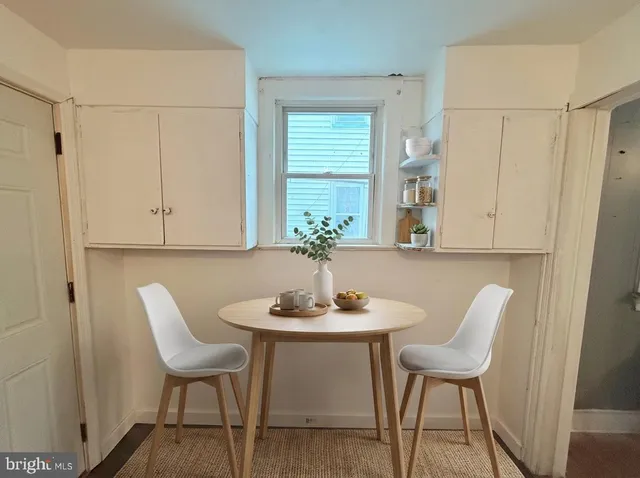 a view of a hallway with wooden floor and stairs