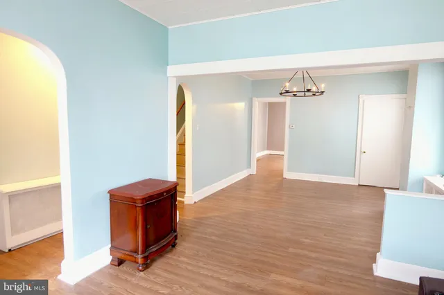 a view of an empty room and wooden floor