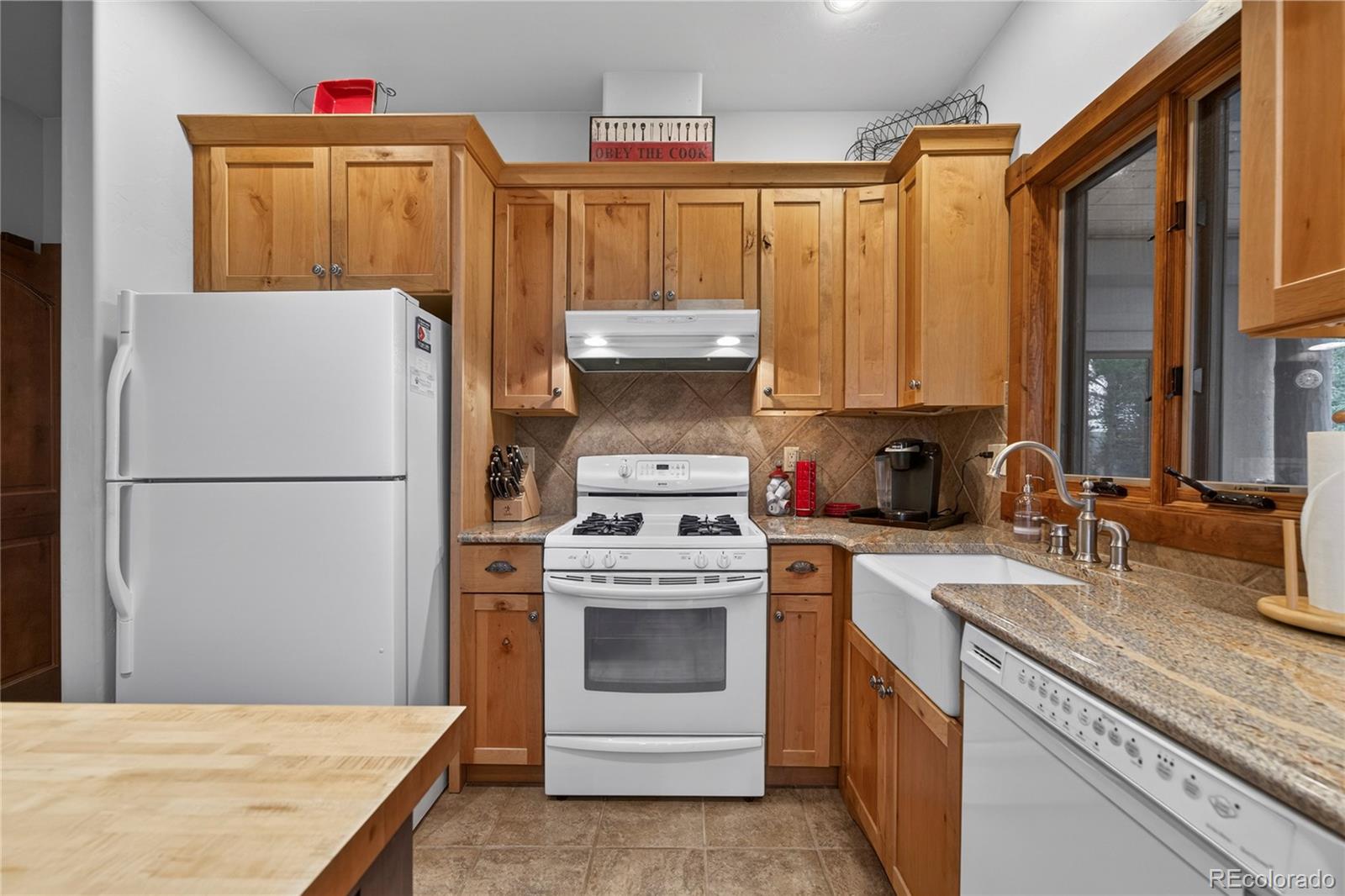 148 County Road Tabernash, CO 80478 - Photo 19 of 45 a kitchen with a stove a sink and a refrigerator
