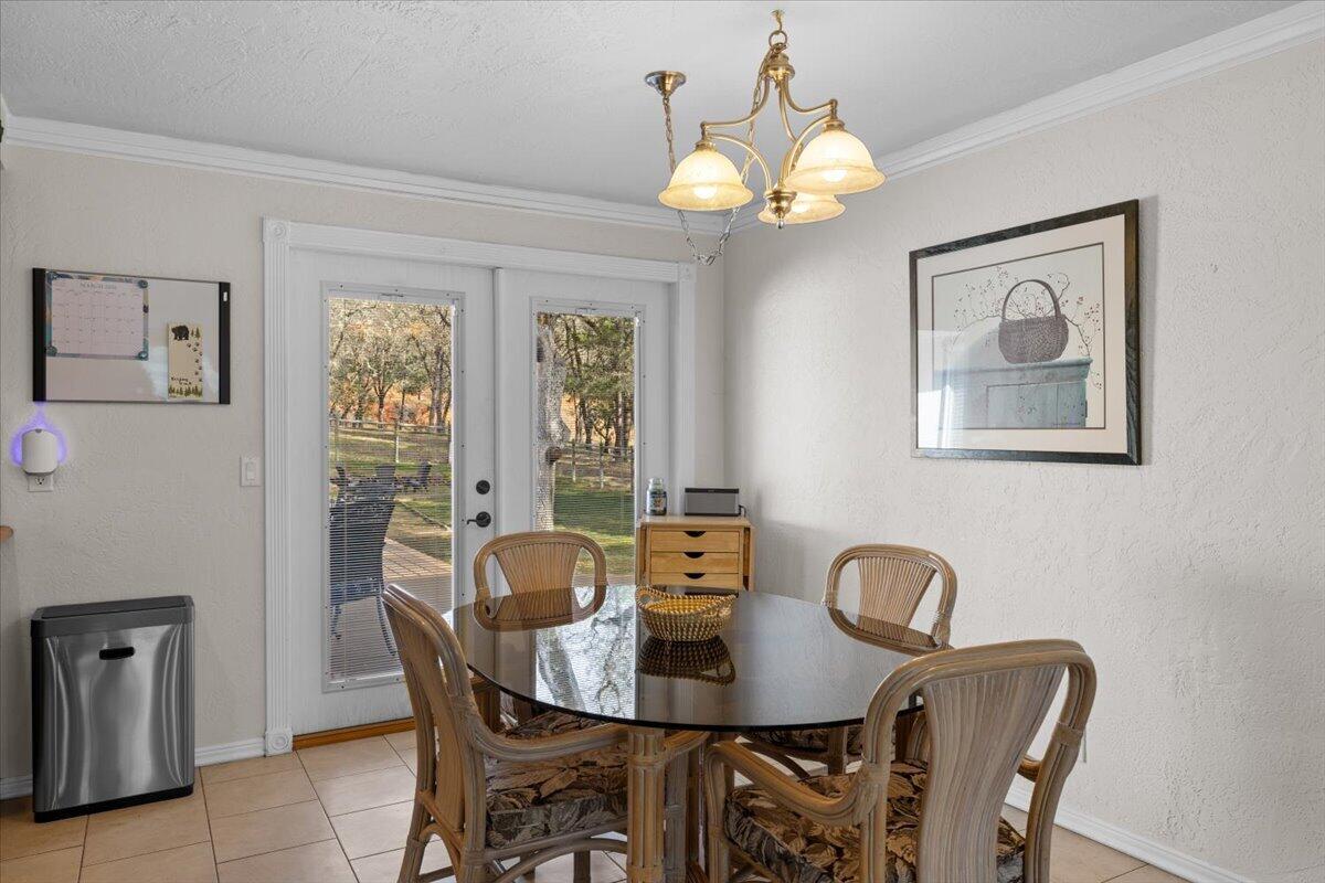 324 China Gulch Road Jacksonville, OR 97530 - Photo 11 of 45 a view of a dining room with furniture and chandelier