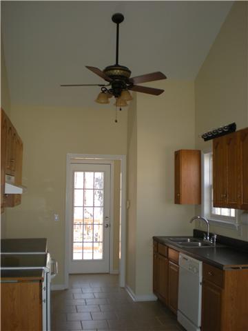 1008 Wildcat Road Dickson, TN 37055 - Photo 11 of 12 a kitchen with a sink a stove cabinets and a window