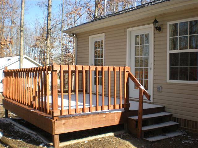 1008 Wildcat Road Dickson, TN 37055 - Photo 3 of 12 a view of a wooden house with a small yard