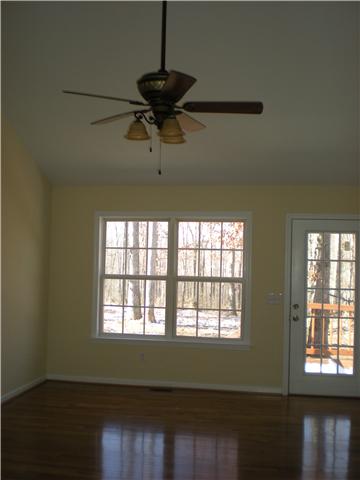 1008 Wildcat Road Dickson, TN 37055 - Photo 6 of 12 a view of an empty room with wooden floor and a window