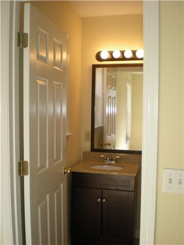 1008 Wildcat Road Dickson, TN 37055 - Photo 9 of 12 a bathroom with a granite countertop sink a mirror and a shower