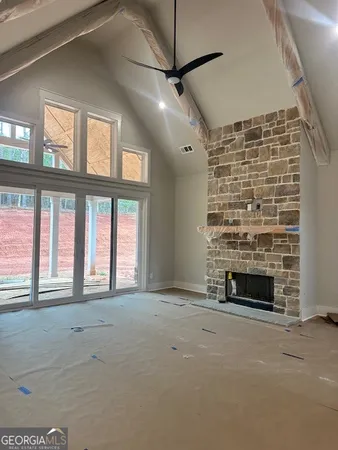 a view of an empty room with a fireplace and a window