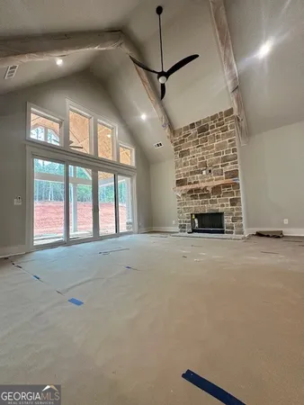 a view of a room that has a chandelier fan and wooden floor