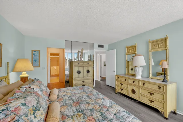 a bedroom with a bed and a dresser in it