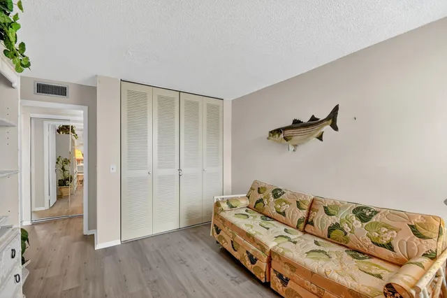 a bedroom with a bed and a wooden floor