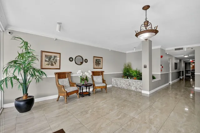 a living room with furniture and potted plant