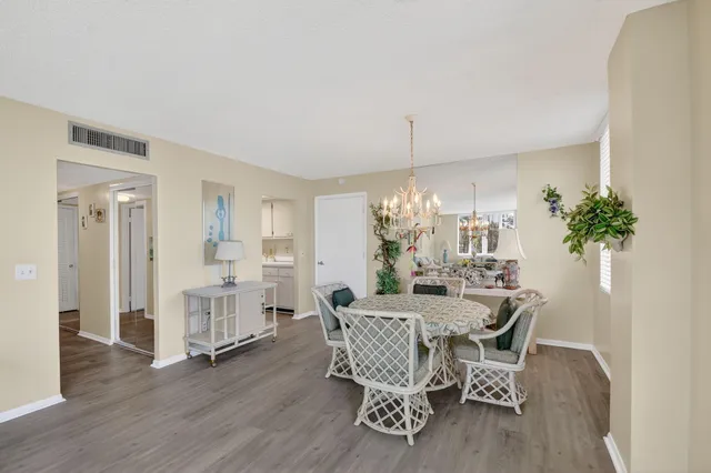 a view of a dining room with furniture and chandelier