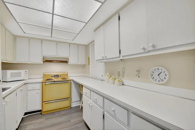 a kitchen with stainless steel appliances granite countertop white cabinets sink and dishwasher