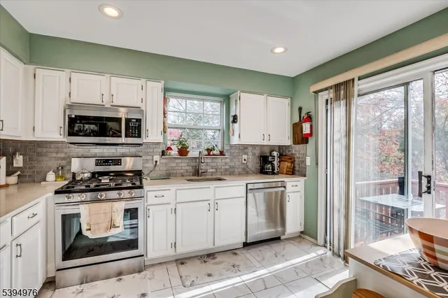 a view of a kitchen with cabinets and outdoor space