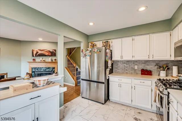 a kitchen with white cabinets sink and white appliances