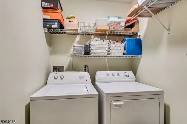a bedroom with a bed and painting on the wall