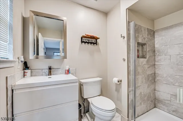 a bathroom with a glass shower door
