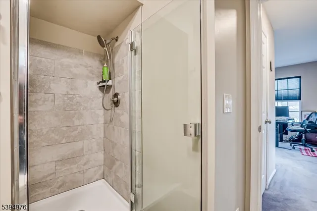 a bedroom with two beds and a flat screen tv