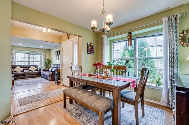 a dining room with furniture a fireplace and wooden floor