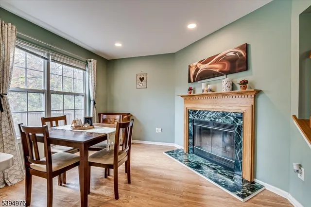 a dining room with furniture and a floor to ceiling window