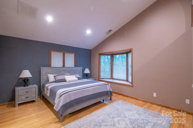 a bedroom with a bed and a window