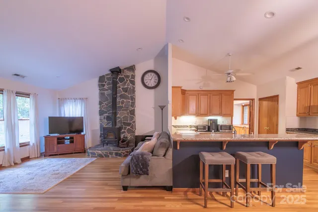 a kitchen with stainless steel appliances granite countertop a stove and cabinets