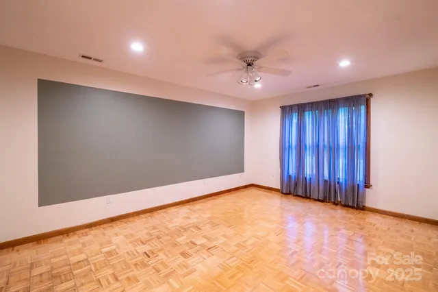 an empty room with a ceiling fan