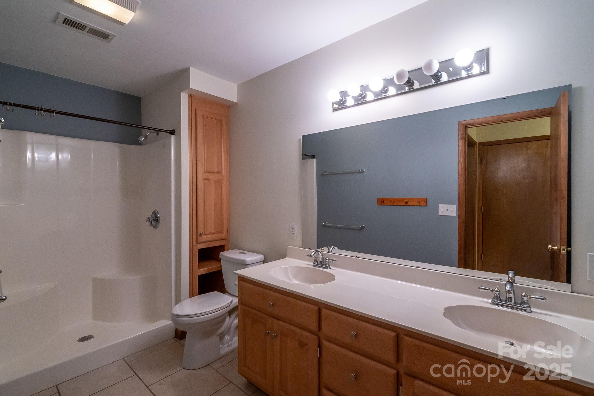 5214 Addison Road Waxhaw, NC 28173 - Photo 23 of 23 a bathroom with a sink a toilet and shower