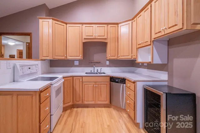 a kitchen with stainless steel appliances granite countertop a sink stove and cabinets