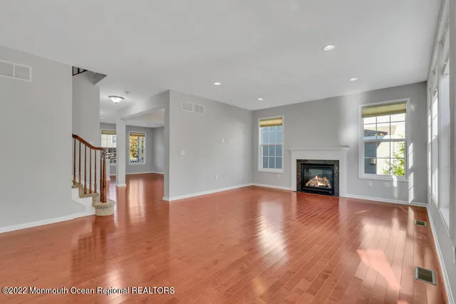 a open kitchen with stainless steel appliances granite countertop a refrigerator a stove top oven a sink dishwasher and wooden cabinets with large window