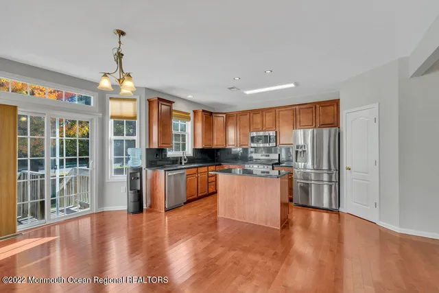 a kitchen with stainless steel appliances granite countertop a refrigerator and a sink