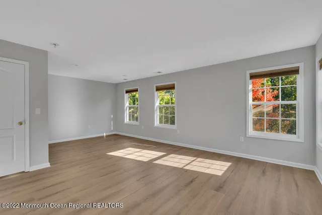 a bathroom with a granite countertop sink a bathtub and window