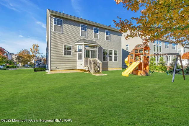 a view of a house with a yard and sitting area