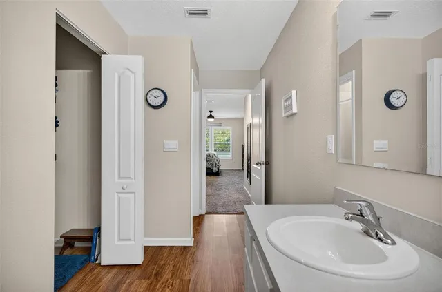 a bathroom with a sink vanity granite and a toilet