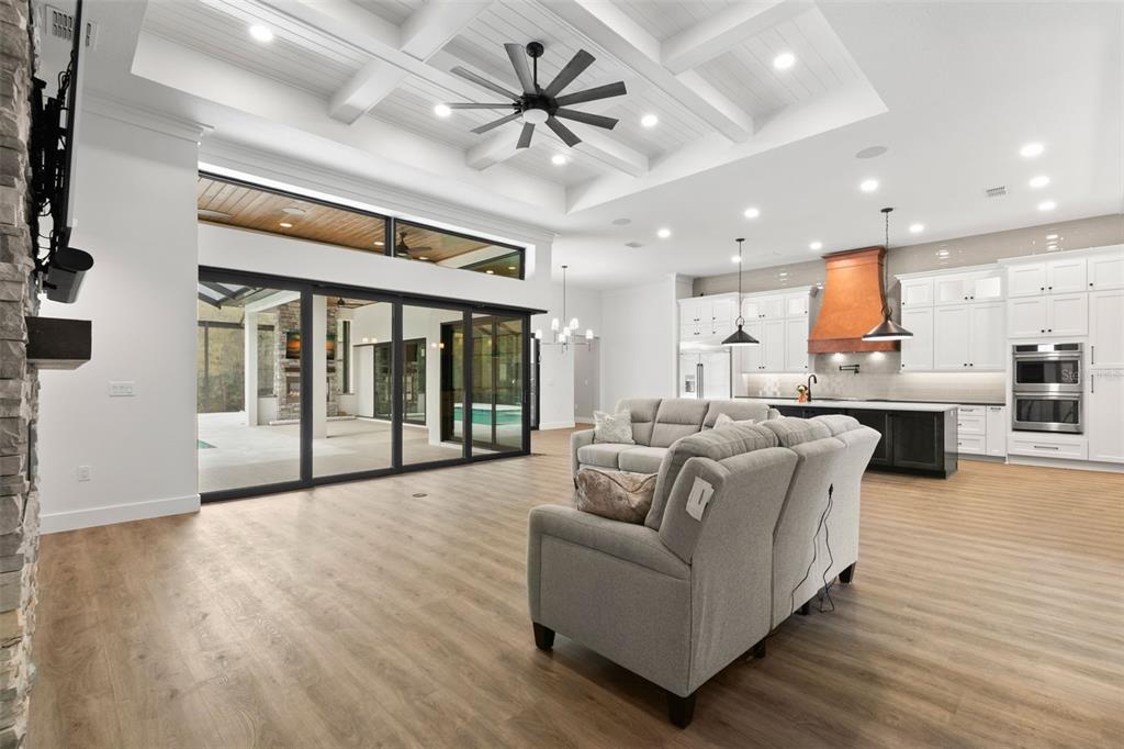 1 Plainview Road, Unit LOT 1 Odessa, FL 33556 - Photo 6 of 16 a living room with furniture and a large window with kitchen view