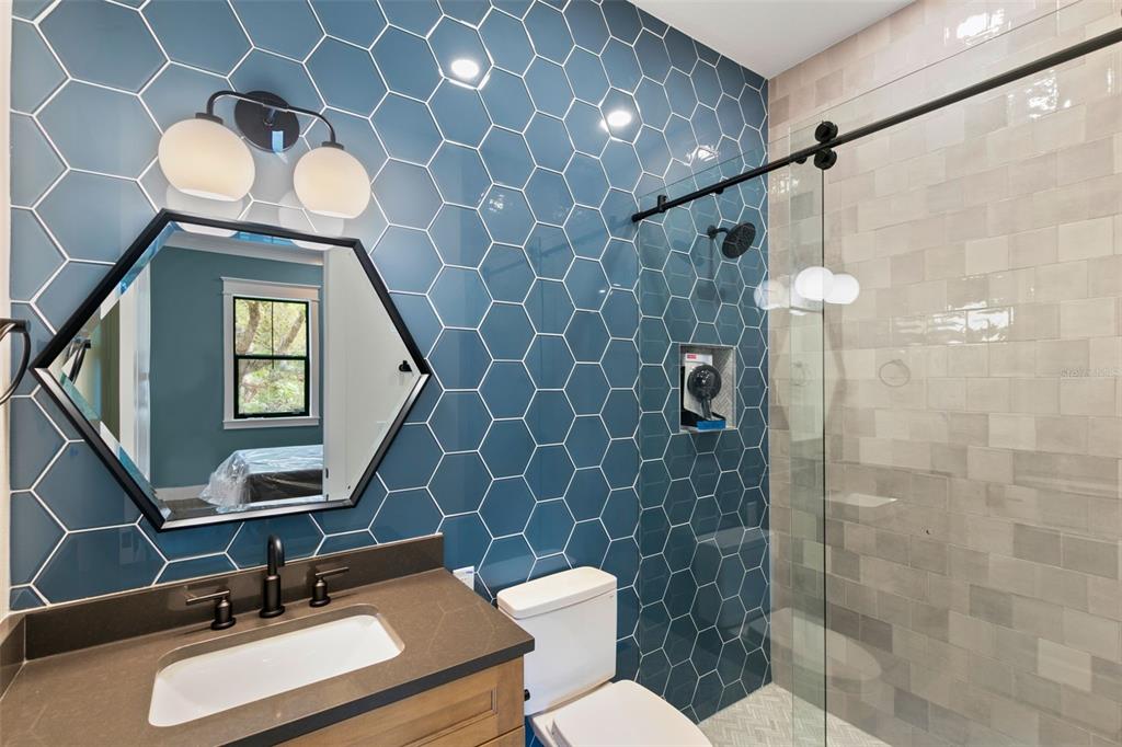 1 Plainview Road, Unit LOT 1 Odessa, FL 33556 - Photo 10 of 16 a bathroom with a toilet a sink and mirror