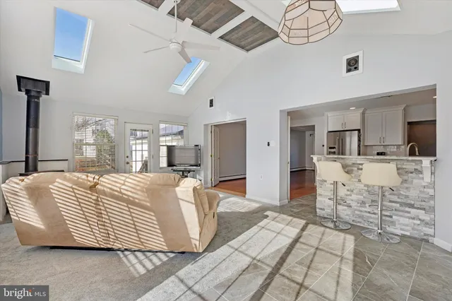 a large bedroom with a bed and glass table